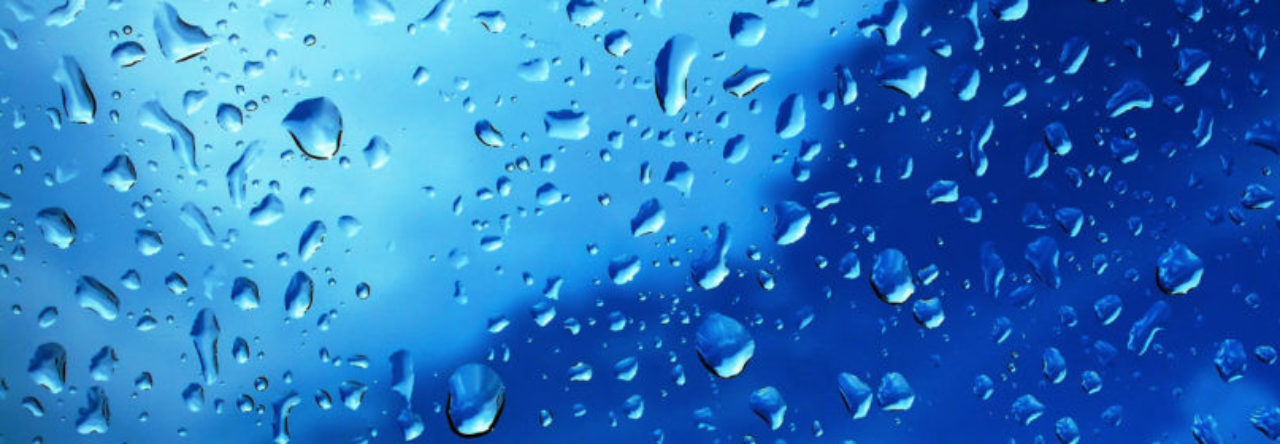 Close-up of water droplets and mineral moisture on exterior window glass